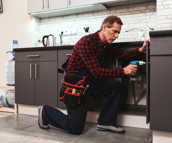 Handyman at work repairing kitchen